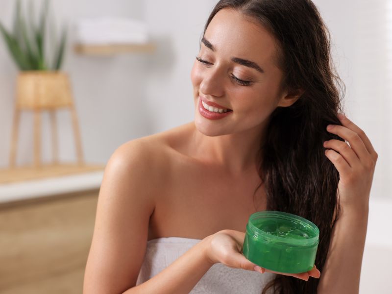 A woman applying hair mask on her hair