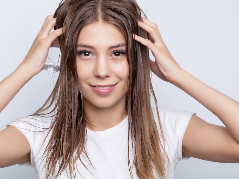 A women massaging her hair