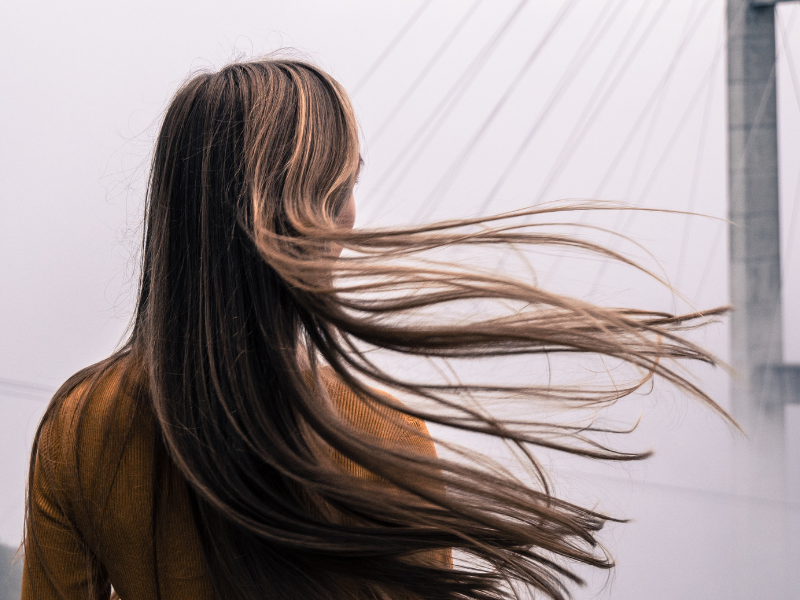 Back view of a woman with natural straight hair