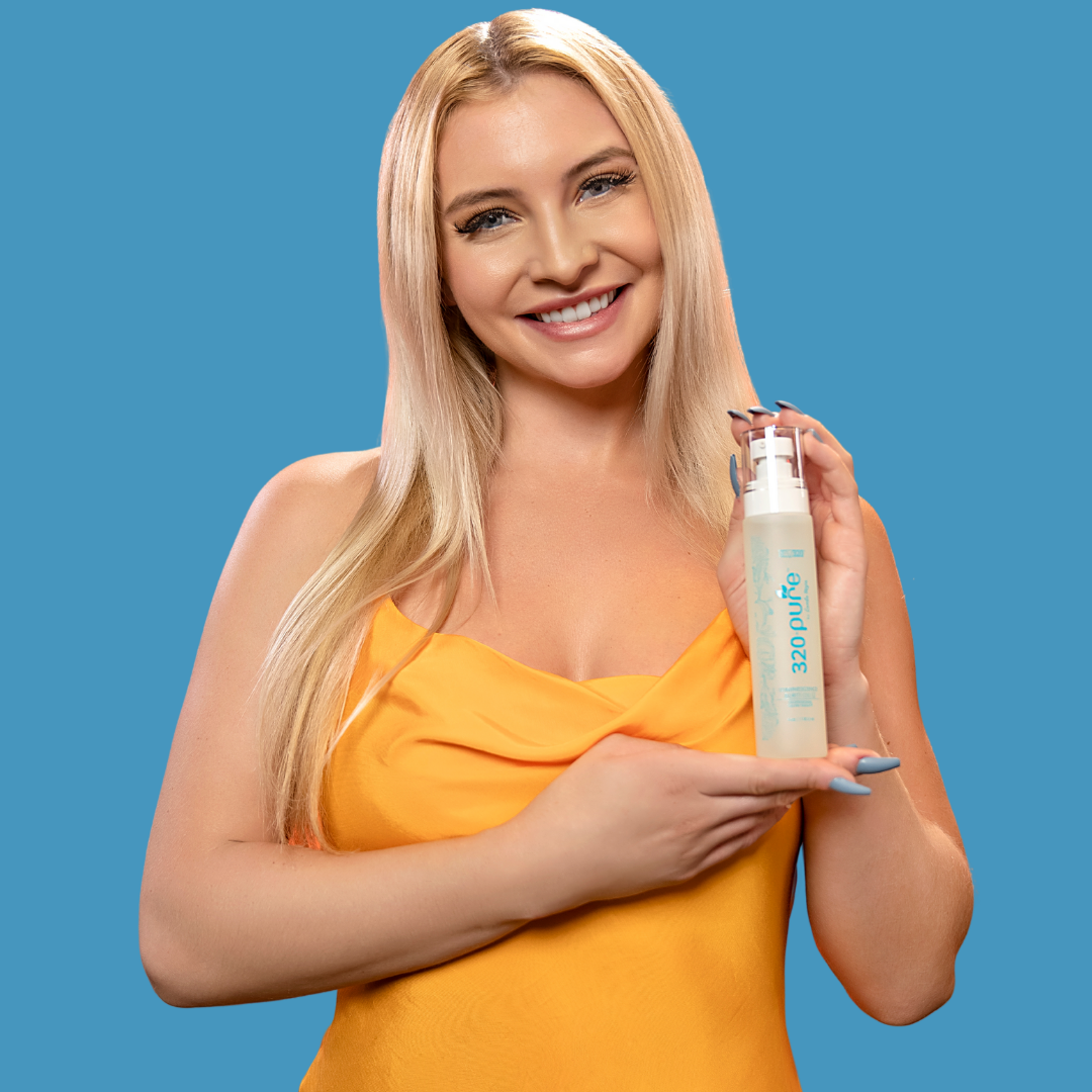 a model holding 320pure luminescence oil while smiling