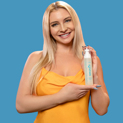 a model holding 320pure luminescence oil while smiling