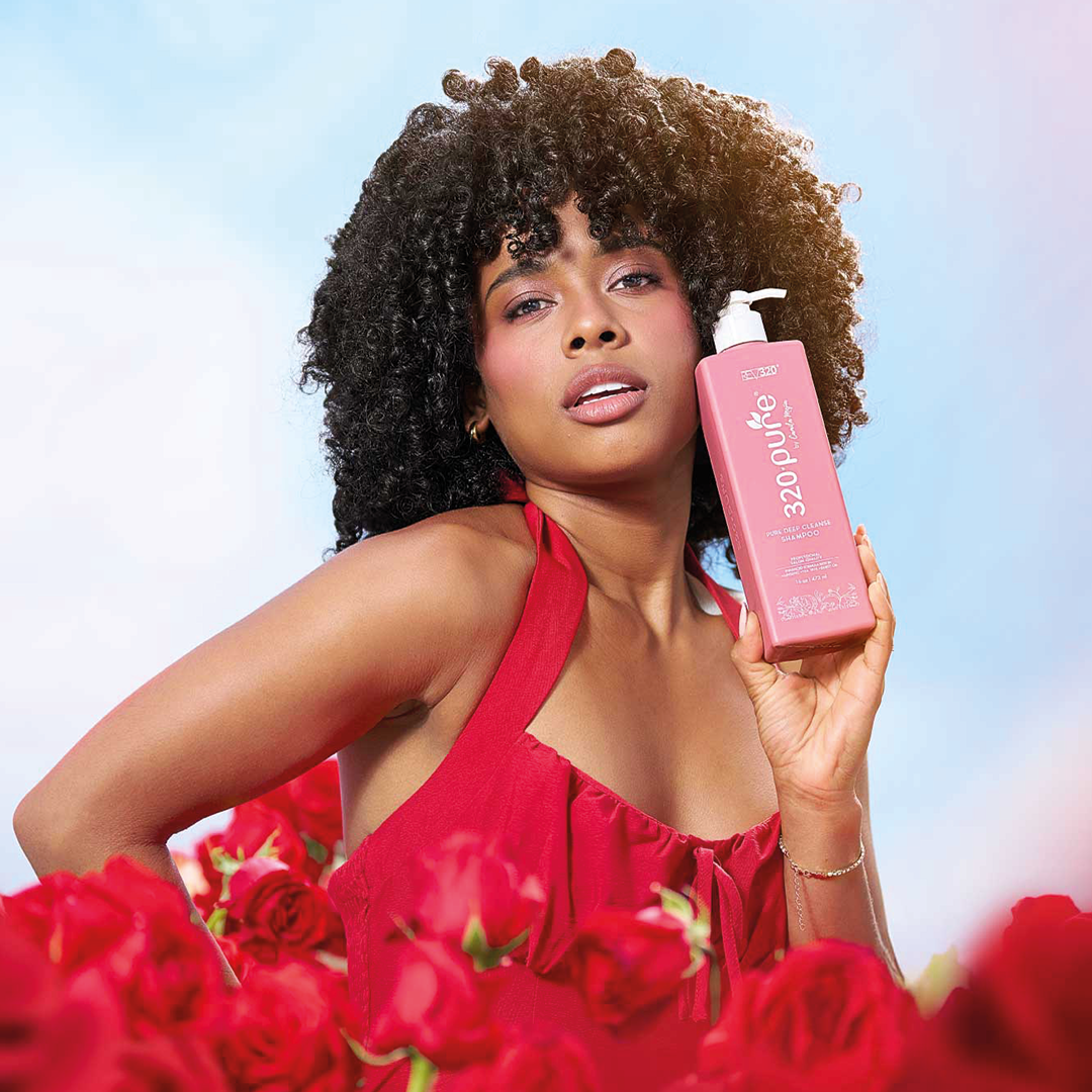 A model holding 320 Pure Deep Cleanse Shampoo